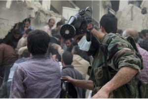 STRINGER / REUTERS FILE PHOTO  A man with a chemical mask on his head searches for survivors from the rubble of a damaged area, what activists said was a result of an airstrike by the Syrian Regime, in Al-Sukkari neighbourhood in Aleppo April 7, 2013.  